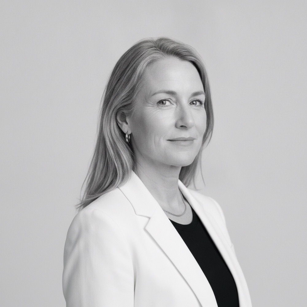 Black and white portrait of Claire Donnelly in a white blazer